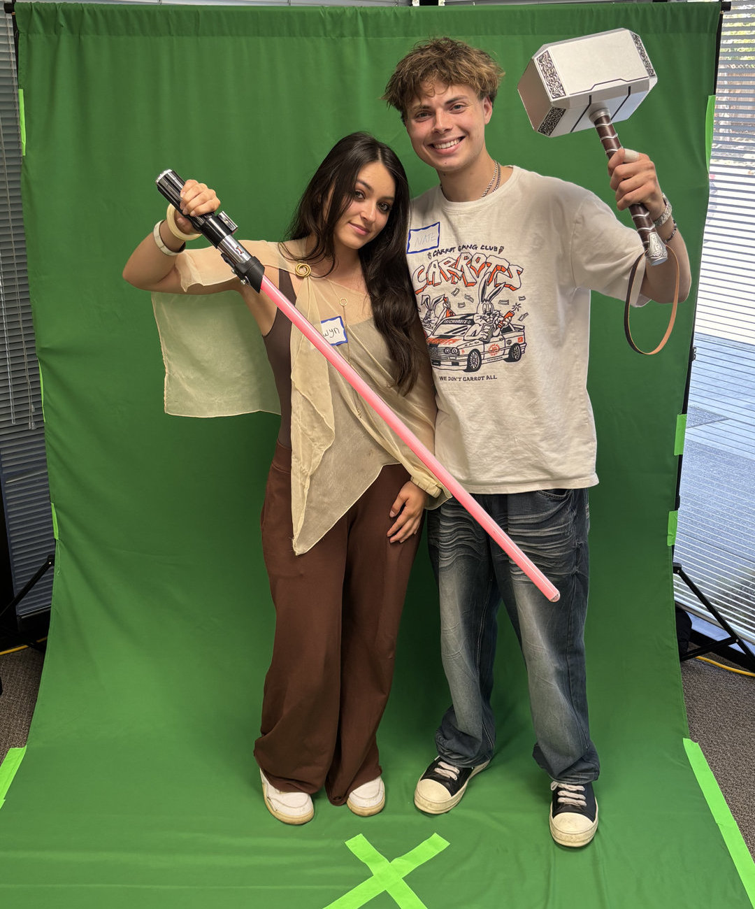 2 people holding props