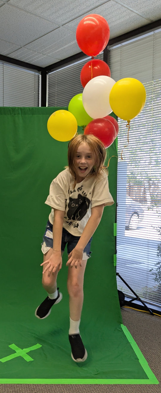 Girl jumping with balloons