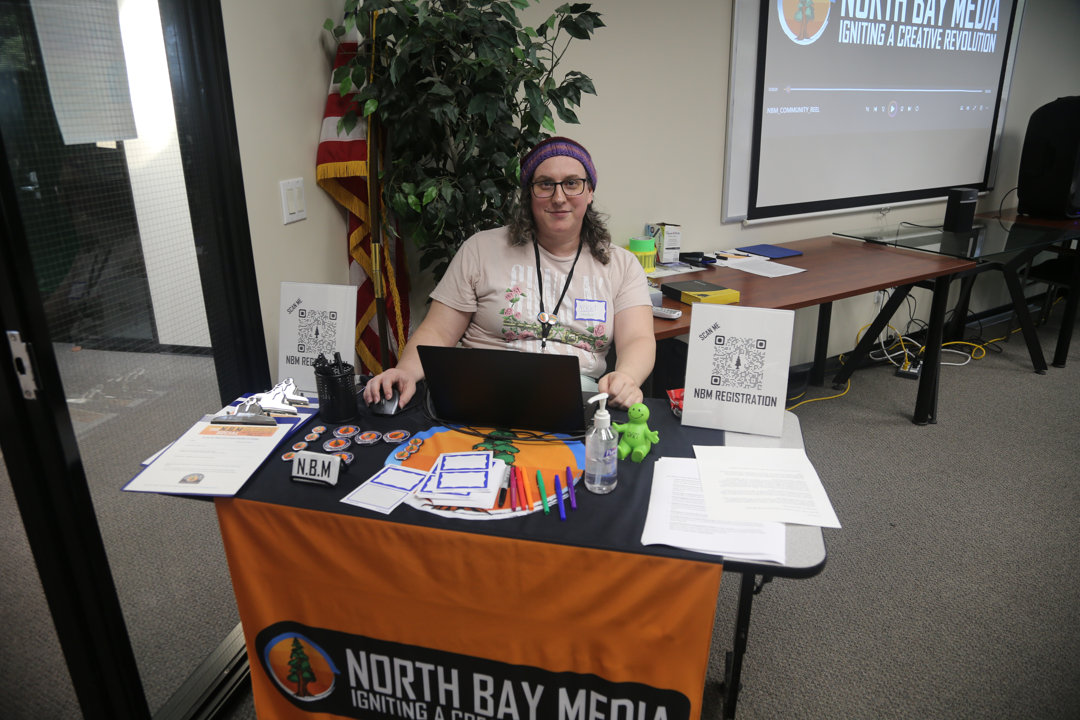 Woman sitting behind registration deck